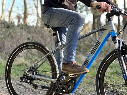 Basis electric bike with pedal assist, perfect for commuting, off-road cycling, and city travel across the UK.