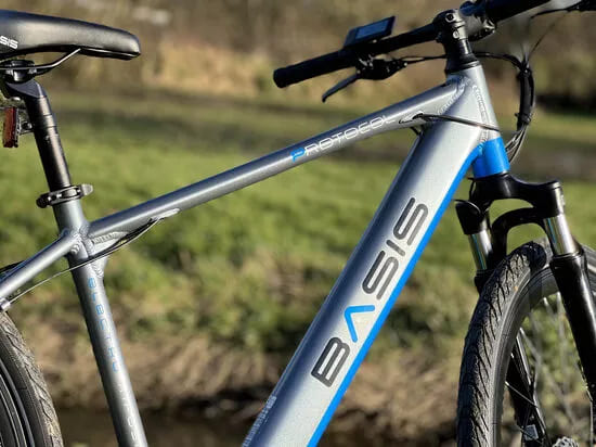 Basis electric bike with pedal assist, perfect for commuting, off-road cycling, and city travel across the UK.